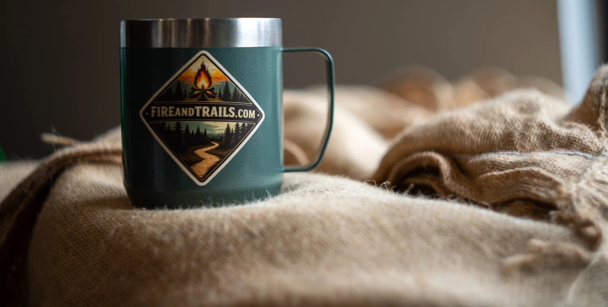 Fire & Trails green coffee mug on warm burlap